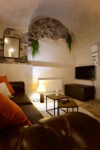 a living room with a couch and a table at Love Room du Château Fort - Jacuzzi & Insolite ! in Mercury