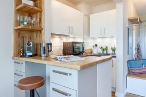 a kitchen with white cabinets and a counter top at Haus Dieksee Holm Dieksee-Idyll in Gremsmühlen