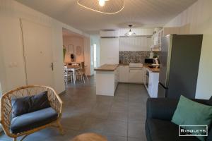 a kitchen and living room with a couch and a table at Superbe T3 climatisé avec WIFI à 400m de la plage in Vias