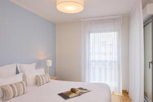 Ένα ή περισσότερα κρεβάτια σε δωμάτιο στο Quality Suites Pau Porte des Pyrenees