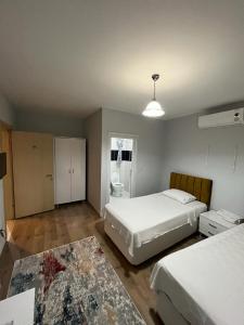 a bedroom with two beds and a bathroom at Elit 61 Hotel in Trabzon