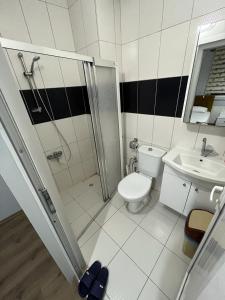 a bathroom with a shower and a toilet and a sink at Elit 61 Hotel in Trabzon +54 photos