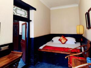 Postel nebo postele na pokoji v ubytování Pingyao Xiangshengyuan Guest House