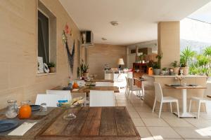 a kitchen and dining room with a table and chairs at Hotel San Giovanni in Polignano a Mare