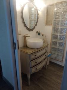 a bathroom with a sink and a mirror on a dresser at Villa Annamaria in Torino di Sangro