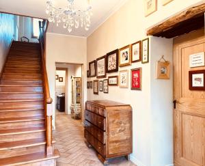 a hallway with a staircase and a chandelier at Casa Agostini Bed and Breakfast in Farra di Soligo