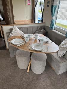 a table with plates and cups on top of a couch at Lighthouse View in Lossiemouth