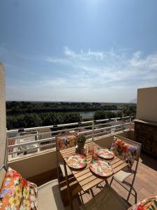 a table and chairs on a balcony with a view at Mar y Sol in Empuriabrava