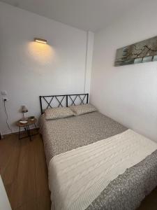 a small bedroom with two beds and a table at Mar y Sol in Empuriabrava