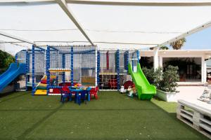 a play area with a playground with a slide at Hotel San Giovanni in Polignano a Mare