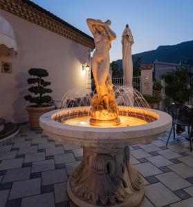 a water fountain with a statue of a squirrel at Hotel Ristorante Borgo La Tana in Maratea