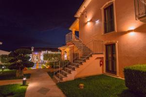 a building with stairs on the side of it at night at Hotel Ristorante Borgo La Tana in Maratea