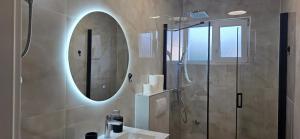 a bathroom with a shower and a sink and a mirror at Luxe Holiday Home in Posedarje +14 photos