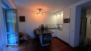 a kitchen with a table and a counter top at Apartament Willa Woda in Jurata
