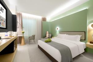 a hotel room with a bed and a desk at Layflat Hotel in Shenzhen