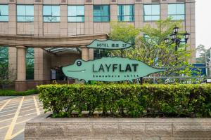 a sign in front of a large building at Layflat Hotel in Shenzhen