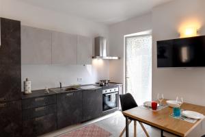 a kitchen with a wooden table and a dining room at Casa Quadrifoglio - Spalavera in Intra