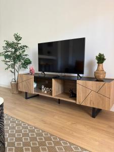 a living room with a flat screen tv on a wooden entertainment center at Casa Dalia - One bedroom flat in Torremolinos