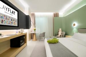 a hotel room with a bed and a desk and a room at Layflat Hotel in Shenzhen