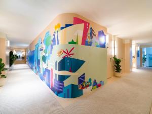 a hallway with a colorful wall in a room at Layflat Hotel in Shenzhen