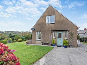 a house with a green door in a yard at 4 Bed in Wisemans Bridge 57793 in Amroth