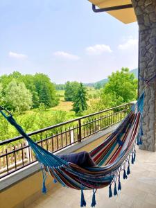 a hammock on a balcony with a view at La Quiete in Caraglio