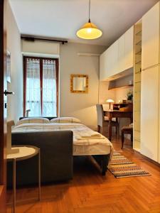 a bedroom with a bed and a dining room at viadanteunovigevano in Vigevano