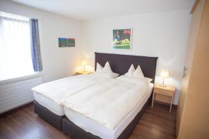 Postel nebo postele na pokoji v ubytování Eiger Guest House - Grindelwald