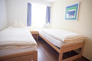 Postel nebo postele na pokoji v ubytování Eiger Guest House - Grindelwald