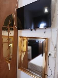 a flat screen tv hanging on a wall at Habitación céntrica en Chamberí in Madrid