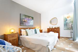 a bedroom with a large white bed and a mirror at Quinta Velha by MY CHOICE in Cabanas de Tavira +207 photos