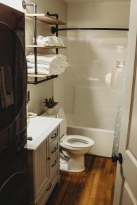 a bathroom with a toilet and a sink and a shower at Corton Lodge Bell Tower Suite Private Riverfront in Clendenin