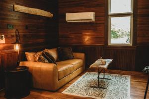 a living room with a couch and a table at Corton Lodge Bell Tower Suite Private Riverfront in Clendenin