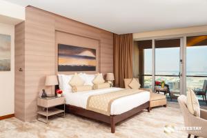 a bedroom with a bed and a large window at Suitestay Address Dubai Mall Residence in Dubai +60 photos