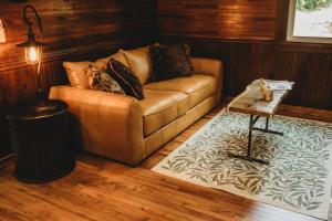 a living room with a couch and a table at Corton Lodge Bell Tower Suite Private Riverfront in Clendenin