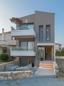 a modern house with a staircase in front of it at Be Modern Aparts & Studios in Limenaria