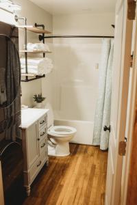 a bathroom with a toilet and a sink and a shower at Corton Lodge Bell Tower Suite Private Riverfront in Clendenin