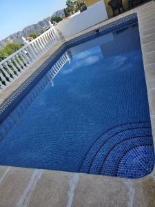 a large blue swimming pool on top of a house at Miradol del Sol in La Nucía