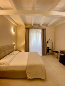 a bedroom with a large bed and a window at Hotel Scilla in Scilla