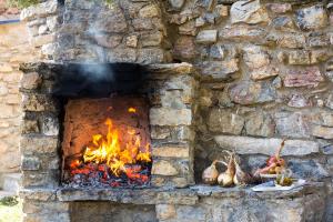 a stone oven with a fire in it at Casa Rural Baró in Tornafort +36 photos