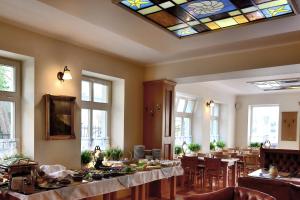 a dining room with tables and a stained glass ceiling at Villa Nautilus in Międzyzdroje
