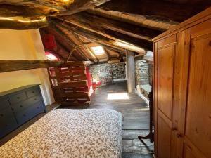 a bedroom with a bed and a wooden ceiling at La Casa Roja de Quirós 