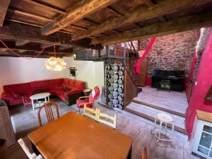 a living room with a red couch and a table at La Casa Roja de Quirós 