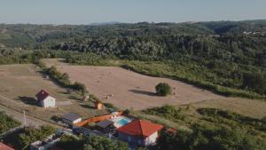 an aerial view of a farm with a large field at Avalska Bajka in Ripanj +35 photos