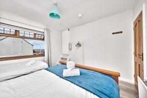 a teddy bear sitting on a bed in a bedroom at Enterprise Escape by Escape Ordinary in Portstewart