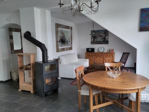 a living room with a wood stove and a table at Stadtvilla in Kiel