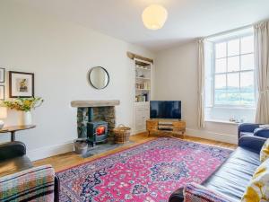 a living room with a couch and a fireplace at 3 Bed in Crosthwaite 75564 in Crosthwaite