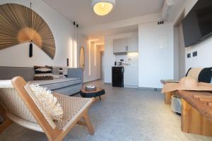 a living room with a couch and a table at Be Modern Aparts & Studios in Limenaria