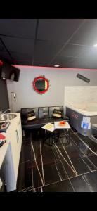 a kitchen with a table and chairs in a room at Ô Saphir Spa - Maison N1 in Denain +7 photos
