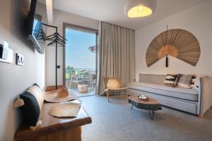 a living room with a couch and a table at Be Modern Aparts & Studios in Limenaria